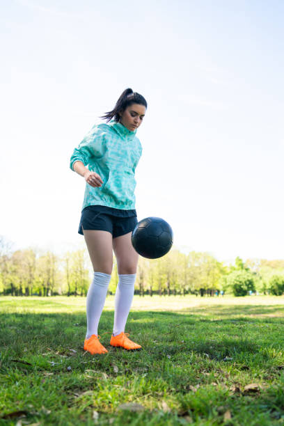 istock Young woman practicing soccer skills with ball. 1273909627