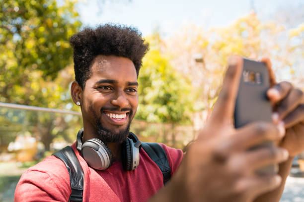 istock Afro man taking selfies with phone. 1273909719