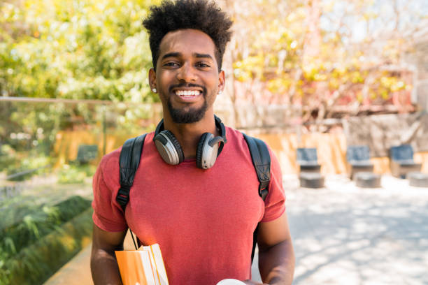 istock Afro university student holding his books. 1273909724