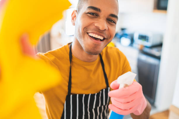 istock Latin man cleaning new home. 1273909750
