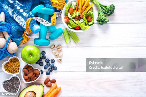 Sports And Healthy Food Background Fruits Vegetables Nuts Dumbbels And Tape Measure Copy Space Stock Photo - Download Image Now