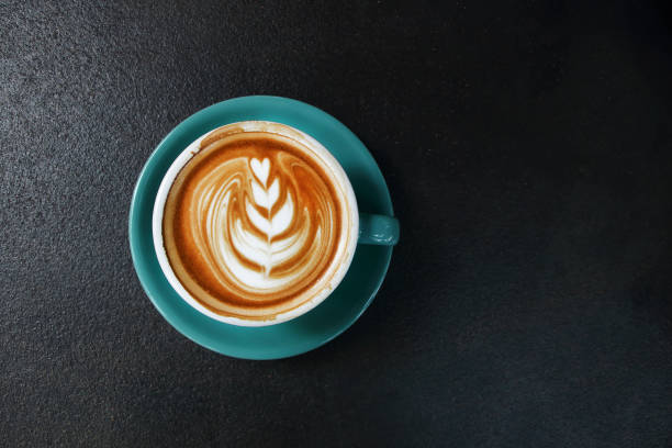 istock one cup of hot latte with saucer on dark rustic cement background 1273912361