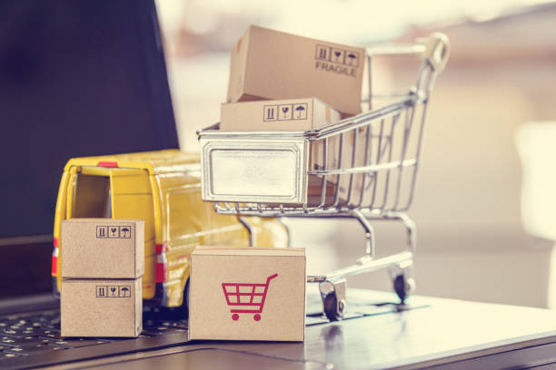 istock Boxes of goods, trolley, delivery van on a laptop computer 1273913228