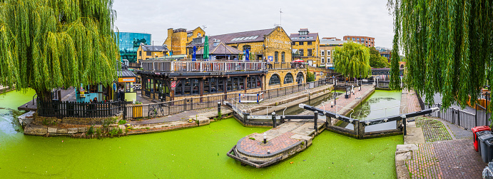 Panoramic view across the Regent Canal basin to Camden Lock’s market stalls, restaurants and bars in the heart of London, the UK’s vibrant capital city.