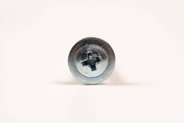 istock Metal or chrome fixing screws on white background. Macro 1273913358