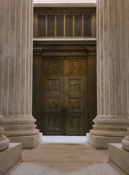 Door to Justice The front door of the United States Supreme Court House taken at night. ruth bader ginsburg stock pictures, royalty-free photos & images