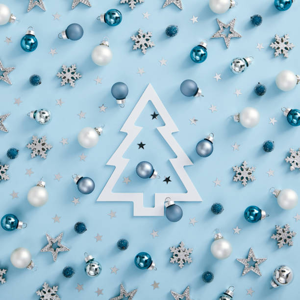istock White and blue bauble, silver snowflake with xmas tree silhouette 1273914722