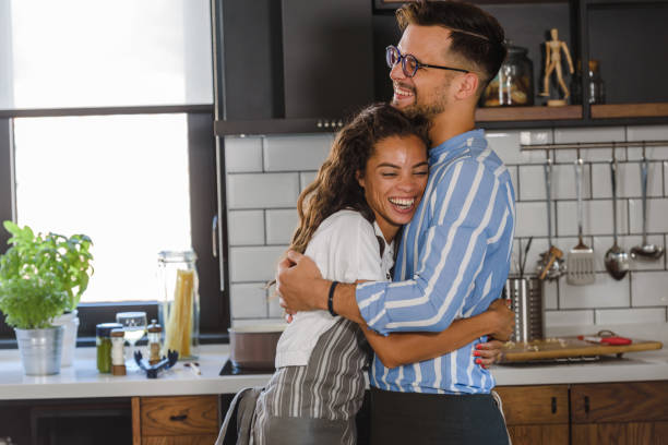 istock Young cheerful multi-ethnic couple preparing pasta together at their modern kitchen 1273915680
