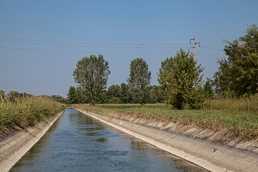 Canal next to the fields in the countryside on a clear summer day