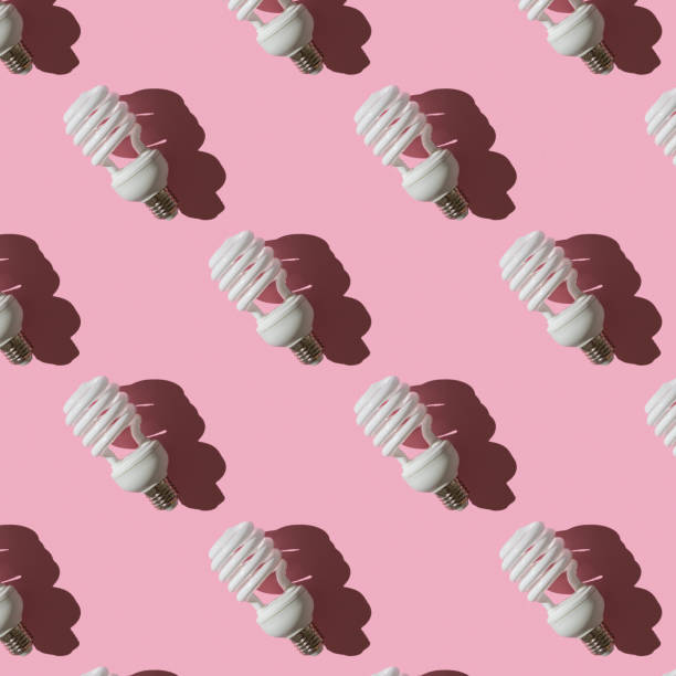 istock Seamless pattern of LED light bulbs  on  pink background. Energy saving concept. Minimalism, top view, flat lay,pattern. 1273916418