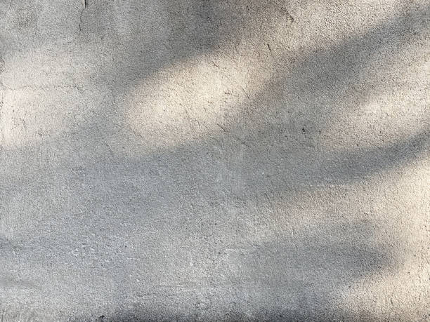 istock Light gray concrete wall texture with shades of light 1273919254