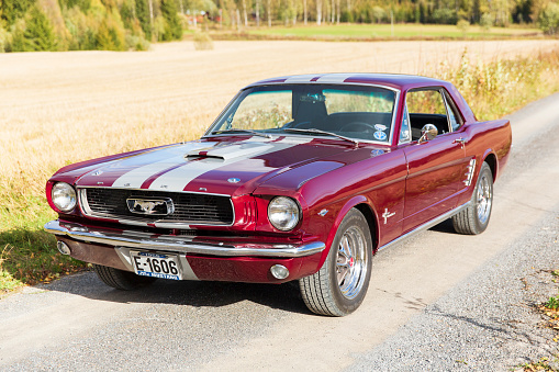 Hamar, Norway -27th of September 2014. Classic, American, muscle car parked in the countryside of Norway. Maroon and gray striped color.