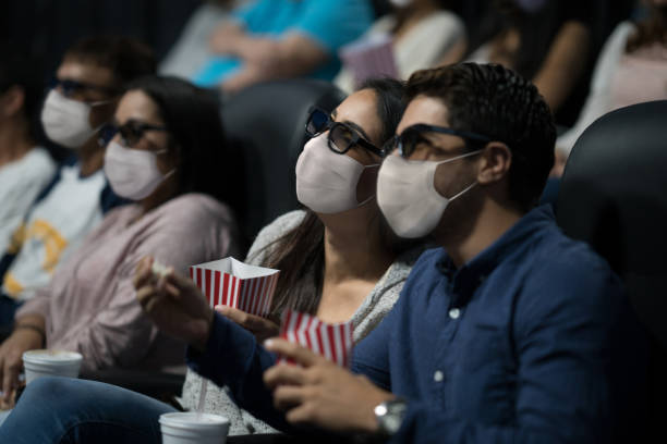 istock People watching a 3D movie during the pandemic wearing facemasks 1273923122