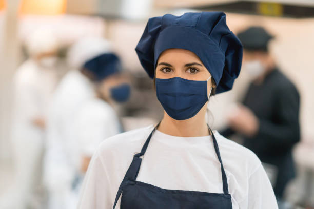 istock Chef working at a restaurant wearing a facemask 1273923142