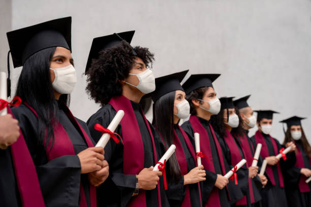 istock Group of students wearing facemasks at their graduation ceremony 1273923158