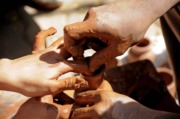 istock Teacher and kid making ceramic pot on pottery wheel 1273924232