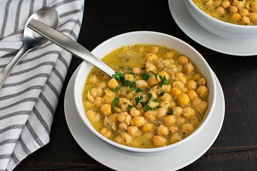 Bowls of Greek soup made with garbanzo beans, lemon, and oregano