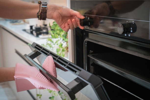 istock Woman is opening the oven in her modern kitchen. 1273927095