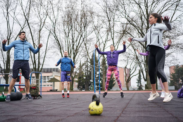 istock Group of young beautiful people doing warm up exercise outdoor 1273927675