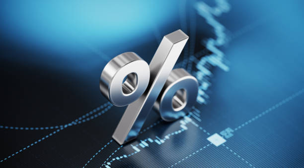 Percentage Sign Sitting over Blue Financial Graph Background - Stock Market and Finance Concept Percentage sign sitting over blue financial graph background. Selective focus. Horizontal composition with copy space. Stock market and finance concept. interest rate photos stock pictures, royalty-free photos & images