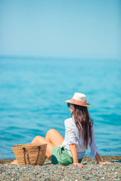 istock Young beautiful woman relax on the beach 1273929787