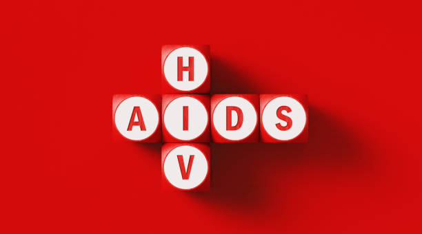 HIV and AIDS written wood blocks sitting on red background. Horizontal composition with copy space. AIDS concept.