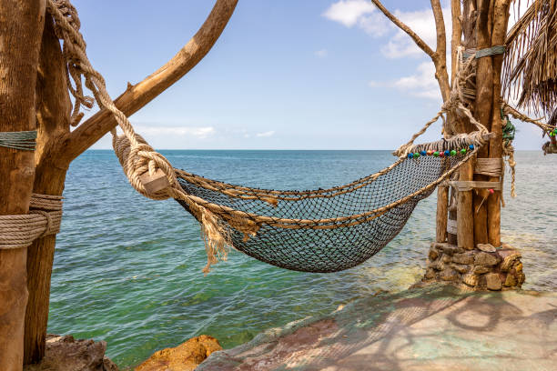 istock Empty hammock on beautiful tropical beach near sea water Thailand 1273930854
