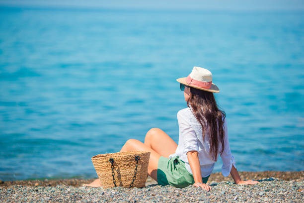 istock Young woman in hat on the beach vacation 1273931121