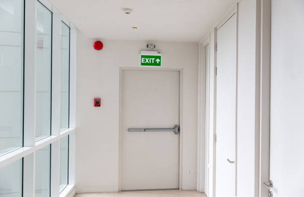 istock Green emergency exit sign showing the way to escape. Fire exit in the building. 1273931318