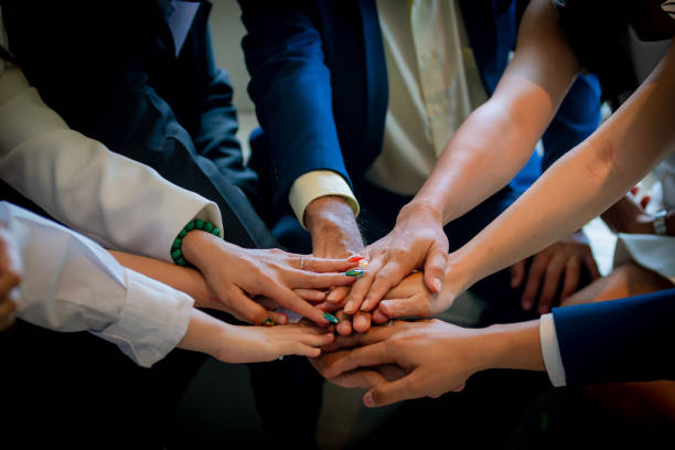 istock People putting their hands together. Friends with stack of hands showing unity and teamwork. Business people join hand together during their meeting. Team work concept. Business people joining hands. 1273931323