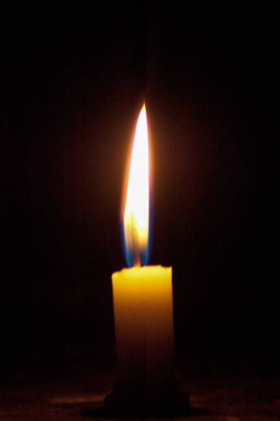 istock A soft warm glowing candle burning in the dark 1273933022
