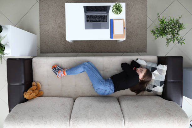 istock Tired from work girl sleeps at home on couch 1273933104
