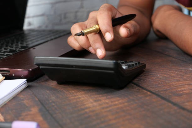 istock Close up of man hand using calculator 1273934723