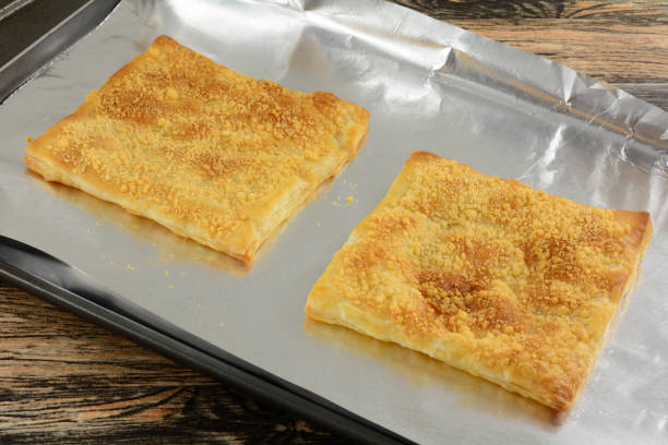istock Baked puff pastry sheets sprinkled with cheese 1273935186