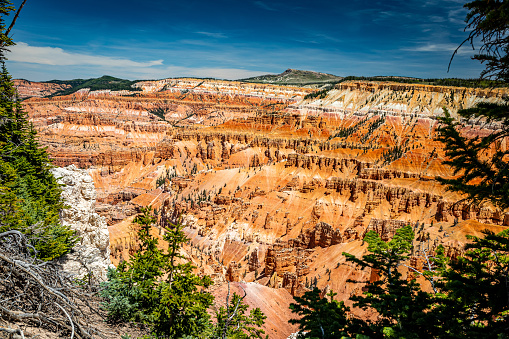 Cedar Breaks National Monument is a natural amphitheater canyon at an elevation of ten thousand feet stretching three miles wide and over a half mile deep near Cedar City, Utah.