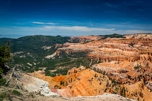 Cedar Breaks National Monument is a natural amphitheater canyon at an elevation of ten thousand feet stretching three miles wide and over a half mile deep near Cedar City, Utah.