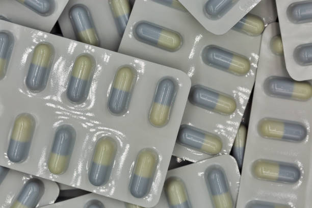 istock Medical capsules in blisters closeup background 1273936049