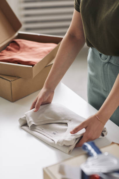 istock Woman packing clothes 1273940791
