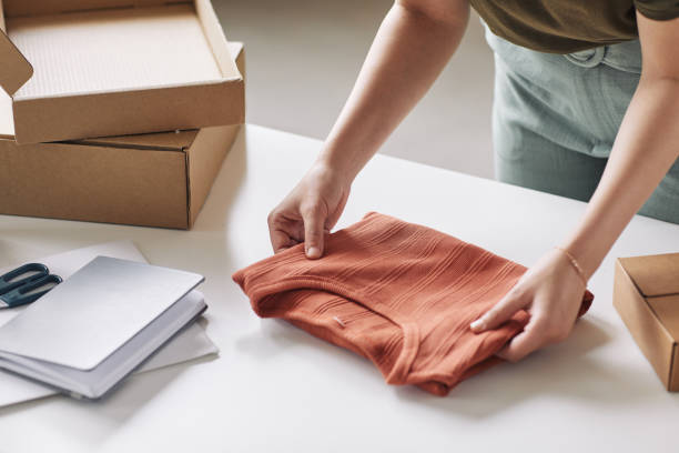 istock Woman packing new shirt 1273940865