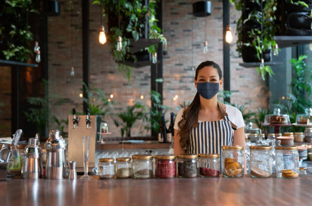Waitres working at a restaurant wearing a facemask during the COVID-19 pandemic