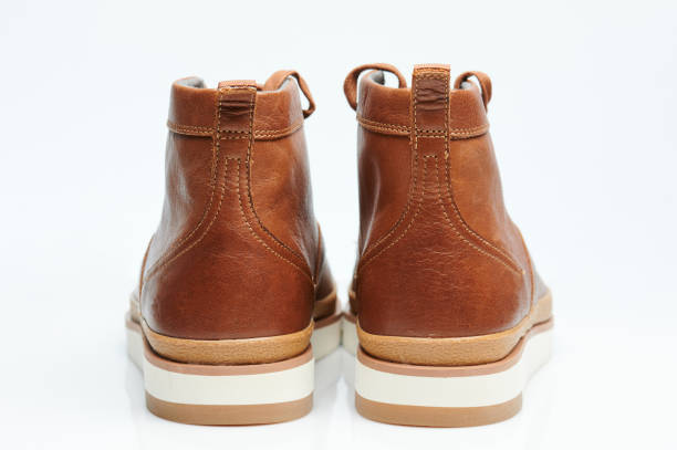 Pair of brown boots rear view isolated on white background