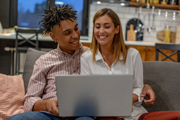 istock Couple at home using laptop on the sofa 1273942368