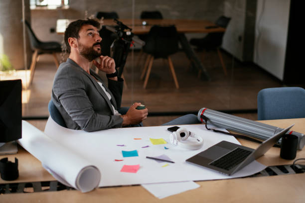 istock Handsome businessman in suit working in the office. 1273950872