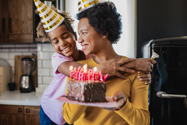 retrato de madre e hija celebrando el cumpleaños en casa - cake birthday domestic kitchen child fotografías e imágenes de stock