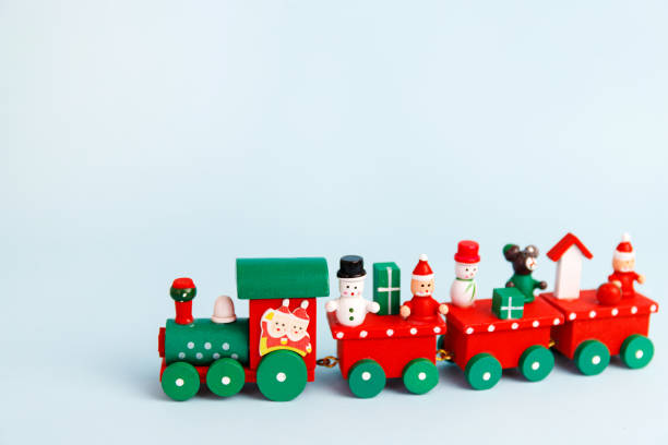 istock Little red christmas toy train on blue background 1273954560