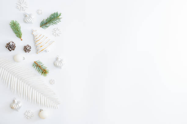 istock Flat lay frame with fir branches and christmas baubles decoration on a white background 1273955683