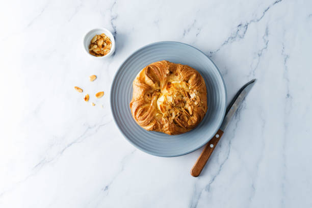 istock Vanilla cream almonds sweet bun in a plate 1273955698