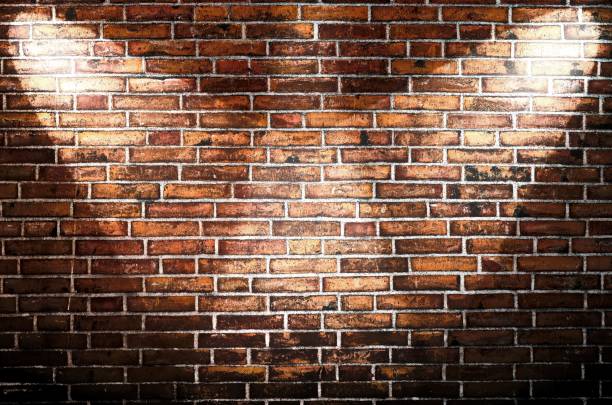 istock Aged and weathered brick wall textures with very bright spotlight illumination 1273955737