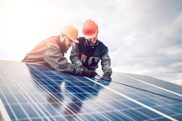 istock Workers Measuring Photovoltaic Cells Dimensions Of Solar Panel 1273975354