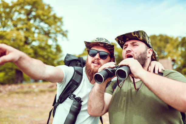 istock Bearded Hikers Trying To Spot Desired Route With Binoculars 1273985159